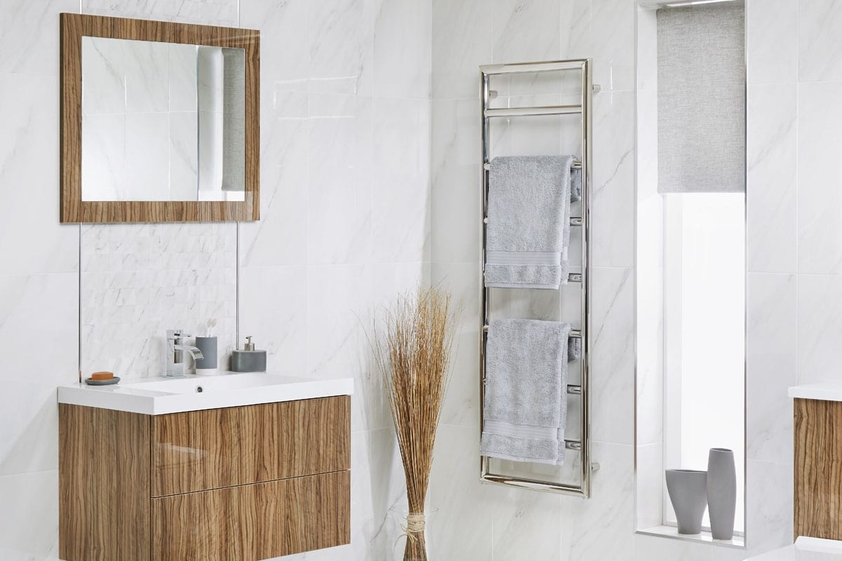 Bright bathroom with towel rail and wooden accents